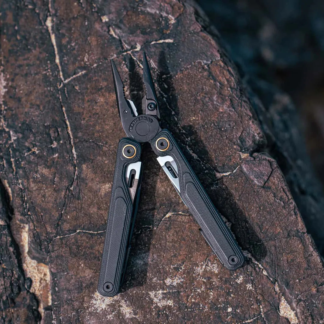 Leatherman Wave Alpha Multi-Tool in Obsidian Black lay on a rock