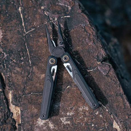 Leatherman Wave Alpha Multi-Tool in Obsidian Black lay on a rock